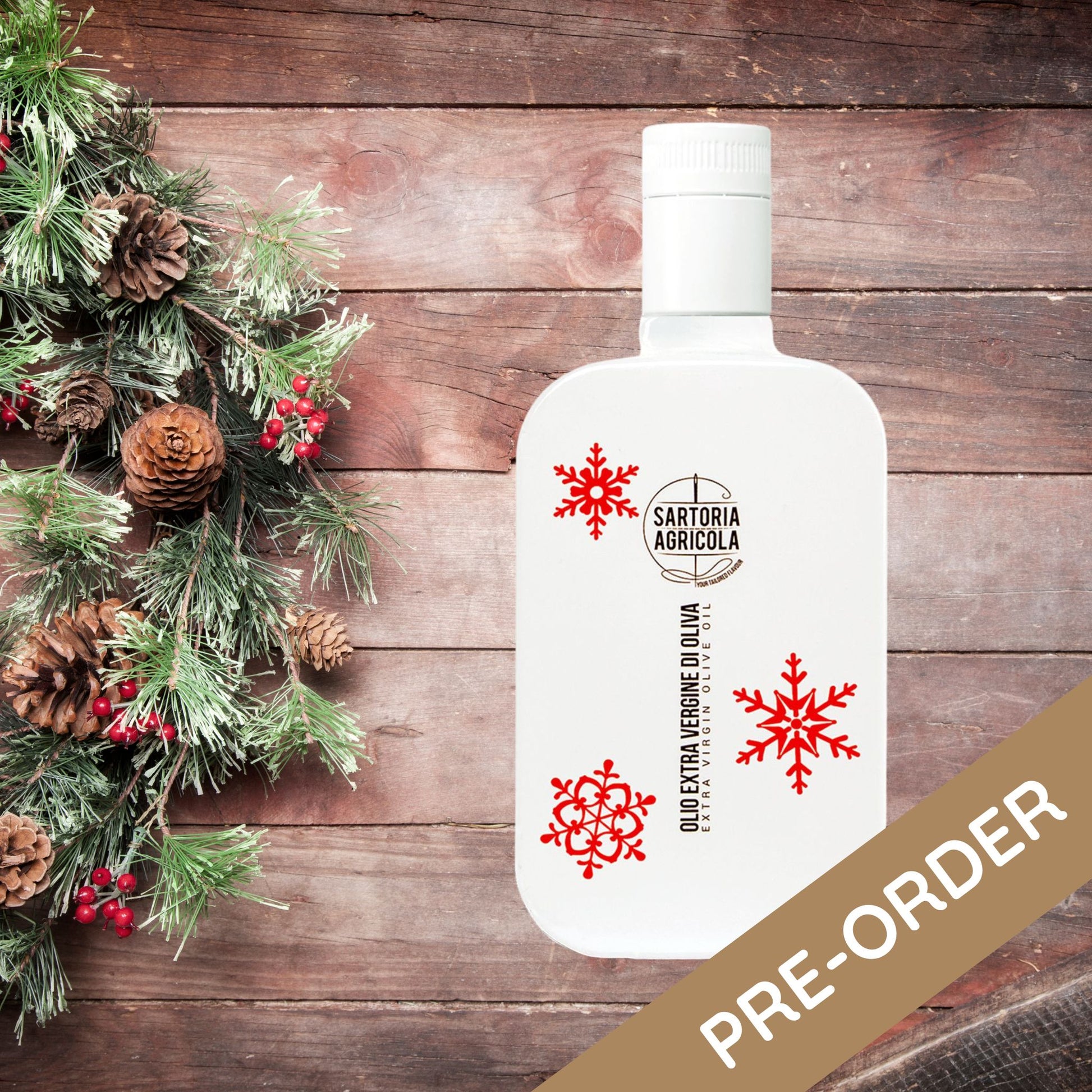 White bottle of extra virgin olive oil, Christmas limited edition crafted in Puglia, with white snowflake design on rustic wood background.